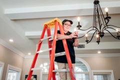 P1088777_Maintenance-Woman_Ladder-Chandelier-Bulb