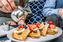 P1211777_WCV_Pouring-Syrup-on-Waffles